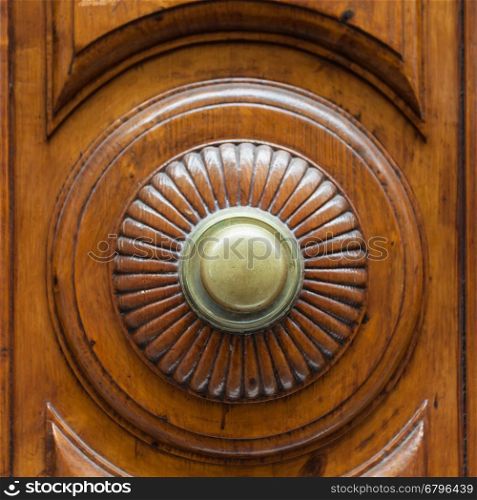 travel to Italy - brass ring knob on wooden door in Florence city