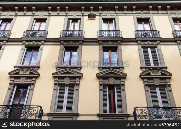 travel to Italy - facade of old urban building with windows and balconies in Florence city