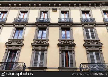 travel to Italy - facade of old urban building with windows and balconies in Florence city