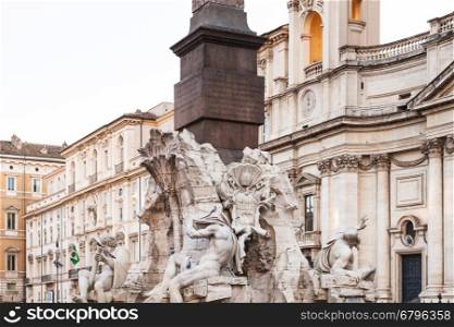 travel to Italy - Fontana dei Quattro Fiumi (Fountain of the Four Rivers) with egyptian obelisk and sant agnese church on background on Piazza Navona in Rome city