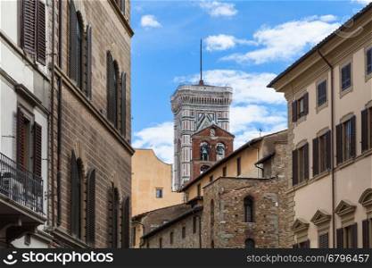 travel to Italy - Giotto's Campanile and bell tower over urban houses in Florence city