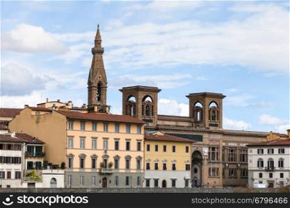 travel to Italy - houses on quay lungarno delle grazie of Arno River and towers of Basilica di Santa Croce (Basilica of the Holy Cross) in Florence city in autumn