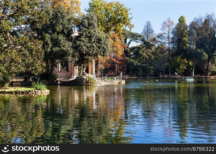 travel to Italy - pond and decorative Temple of Aesculapius in Villa Borghese public gardens in Rome city in autumn