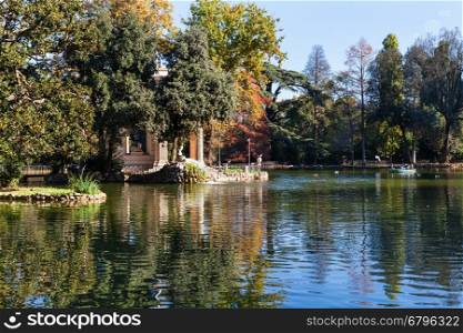 travel to Italy - pond and decorative Temple of Aesculapius in Villa Borghese public gardens in Rome city in autumn