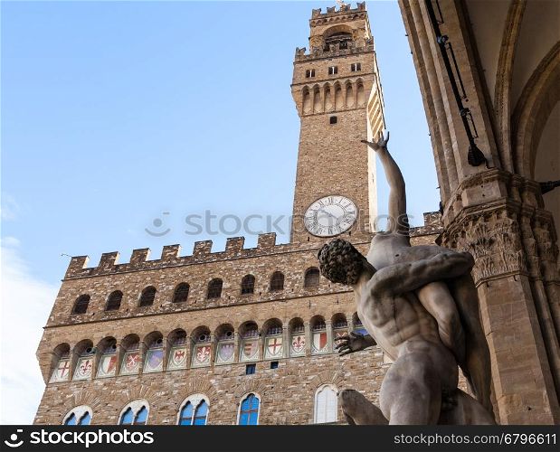 travel to Italy - sculpture The Rape of the Sabine Women and Palazzo Vecchio on Piazza della Signoria in Florence city.