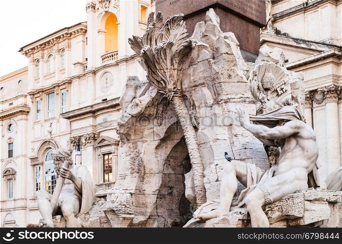 travel to Italy - sculptures of Fontana dei Quattro Fiumi (Fountain of the Four Rivers) and sant agnese church on background on Piazza Navona in Rome city
