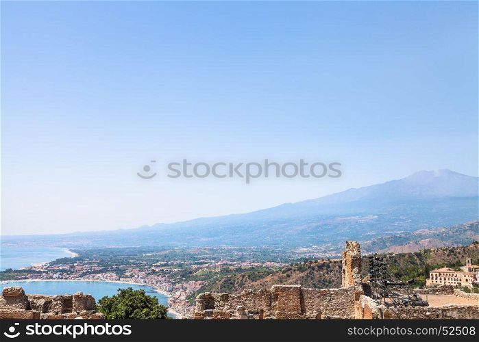 travel to Sicily, Italy - blue sky over Mount Etna, Giardini Naxos town on Ionian sea coast and Taormina city in summer day