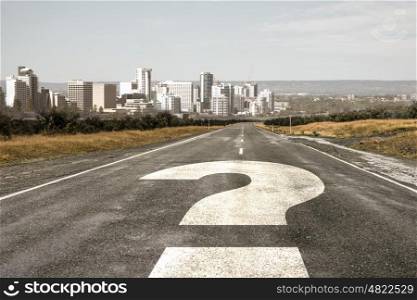 Travel to unknown destination. Cityscape and question mark drawn on asphalt road