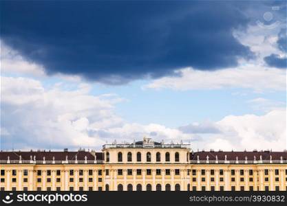 travel to Vienna city - dark storm cloud in blue sky over Schloss Schonbrunn palace, Vienna, Austria
