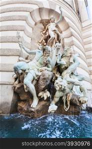 travel to Vienna city - fountain The power of the Sea at Michaelertrakt (St. Michael&rsquo;s Wing) on Michaelerplatz square of Hofburg Palace in Vienna, Austria