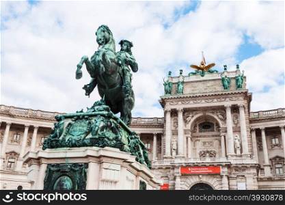 travel to Vienna city - statue of Prince Eugene of Savoy on Heldenplatz and facade of Neue Burg in Hofburg Palace, Vienna, Austria