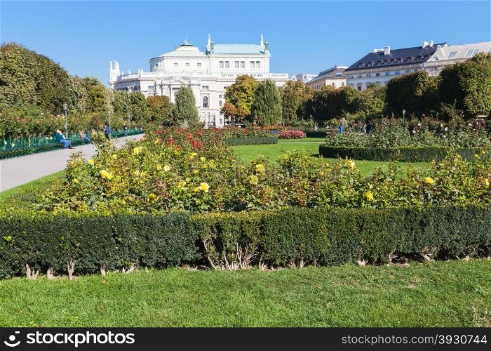 travel to Vienna city - Volksgarten (People&rsquo;s Garden) public park and view of Burgtheater building, Hofburg, Vienna, Austria.