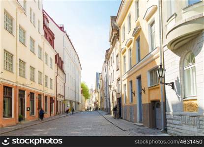 travel, tourism and european architecture concept - old town street in tallinn city in estonia