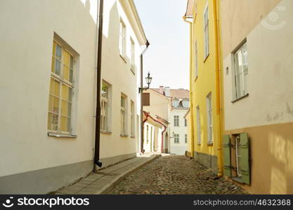 travel, tourism and european architecture concept - old town street in tallinn city in estonia