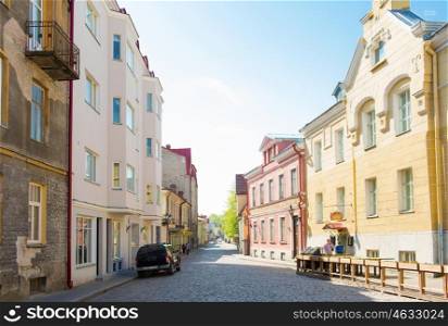 travel, tourism and european architecture concept - old town street in tallinn city in estonia