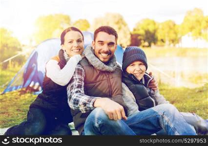 travel, tourism and hike concept - happy family over tent at camp site. happy family with tent at camp site