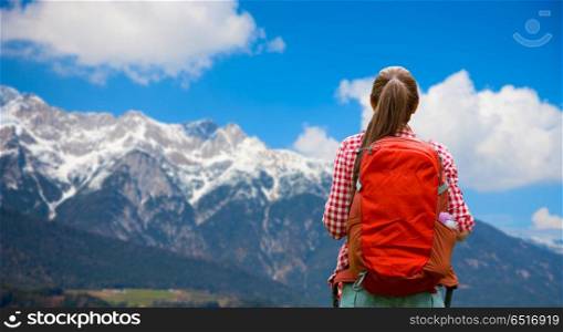 travel, tourism and hike concept - young woman with backpack over alps mountains background. woman with backpack over alps mountains. woman with backpack over alps mountains