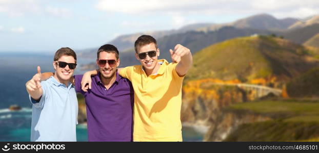 travel, tourism and male friendship concept - group of friends hugging over bixby creek bridge on big sur coast of california background. group of male friends hugging over big sur coast. group of male friends hugging over big sur coast