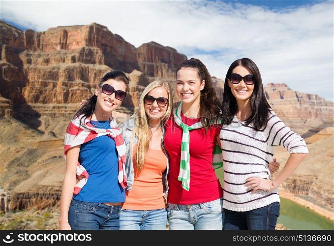 travel, tourism and people concept - beautiful teenage girls or young women over grand canyon national park background. teenage girls or young women over grand canyon. teenage girls or young women over grand canyon