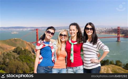 travel, tourism and people concept - beautiful teenage girls or young women over golden gate bridge in san francisco bay background. happy young women over golden gate bridge. happy young women over golden gate bridge