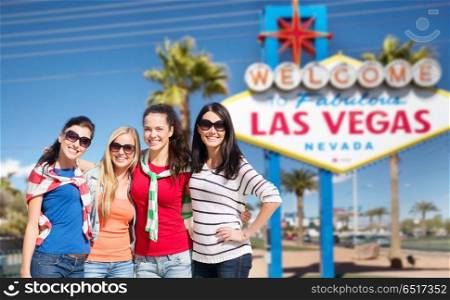 travel, tourism and people concept - beautiful teenage girls or young women over welcome to fabulous las vegas sign background. young women over welcome to las vegas sign. young women over welcome to las vegas sign