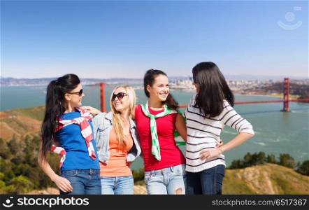 travel, tourism and people concept - beautiful teenage girls or young women over golden gate bridge in san francisco bay background. happy young women over golden gate bridge. happy young women over golden gate bridge