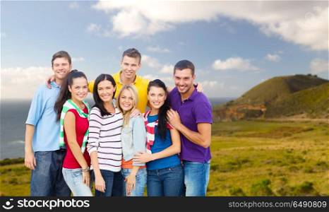 travel, tourism and people concept - group of happy friends over big sur coast of california background. group of happy friends over big sur coast. group of happy friends over big sur coast