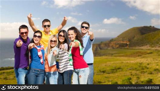 travel, tourism and people concept - group of happy friends pointing at you over big sur coast of california background. happy friends pointing at you over big sur coast. happy friends pointing at you over big sur coast