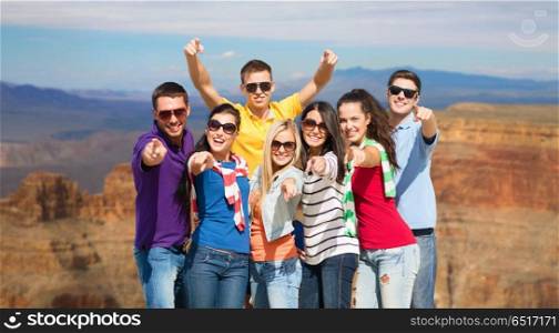 travel, tourism and people concept - group of happy friends pointing at you over grand canyon national park background. happy friends pointing at you over grand canyon. happy friends pointing at you over grand canyon