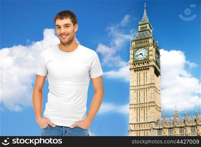 travel, tourism and people concept - handsome man in blank white t-shirt over big ben clock tower and blue sky background