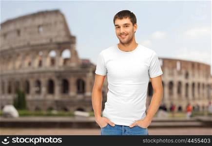 travel, tourism and people concept - handsome man in blank white t-shirt over coliseum background