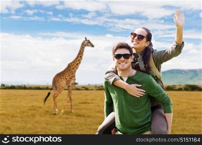 travel, tourism and people concept - happy couple in sunglasses with backpacks having fun and waving hand over giraffe in african savannah background. happy couple with backpacks having fun in africa