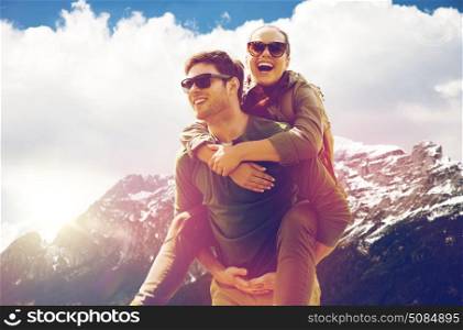 travel, tourism and people concept - happy couple with backpacks having fun over alps mountains background. happy couple with backpacks traveling in highlands. happy couple with backpacks traveling in highlands