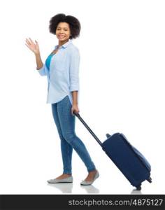 travel, tourism and people concept - smiling young woman with bag waving hand