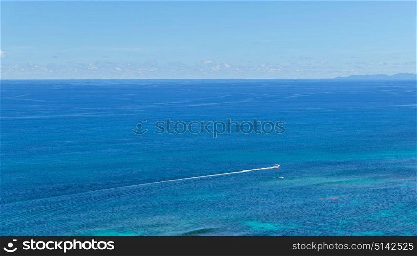travel, tourism and seascape concept - boat sailing in ocean or sea. boat sailing in ocean or sea