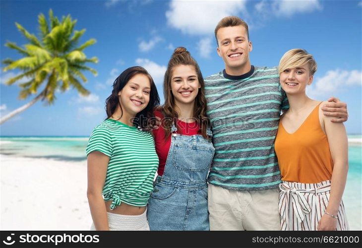 travel, tourism and summer holidays concept - group of happy smiling friends hugging over exotic tropical beach background. happy friends hugging over beach background