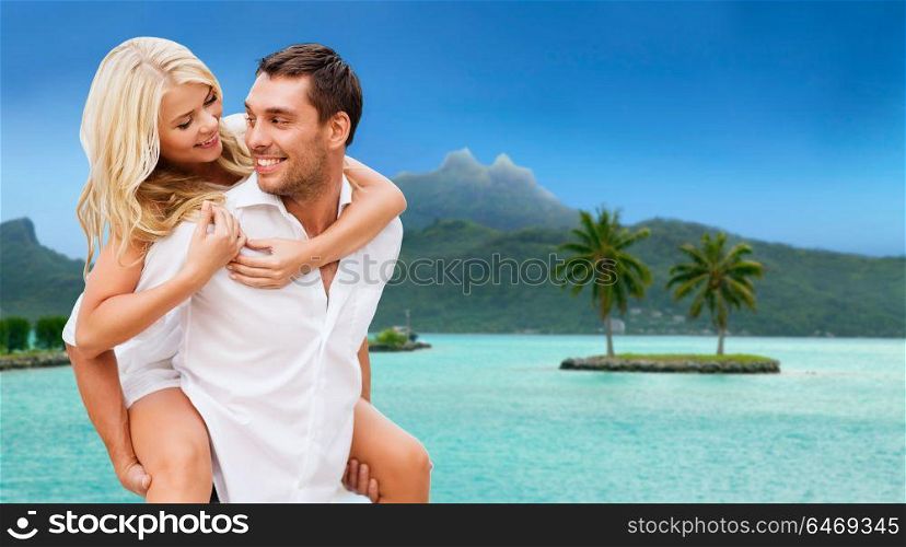 travel, tourism and summer holidays concept - happy couple having fun at touristic resort over exotic bora bora island background. happy couple over bora bora background
