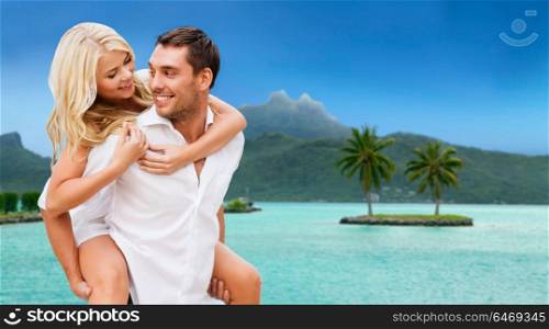 travel, tourism and summer holidays concept - happy couple having fun at touristic resort over exotic bora bora island background. happy couple over bora bora background