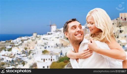 travel, tourism and summer holidays concept - happy couple hugging over oia town on santorini island background. happy couple hugging over santorini island