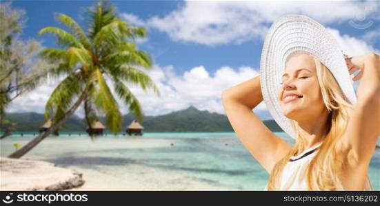travel, tourism and summer vacation concept - beautiful woman in hat enjoying sun over tropical beach background in french polynesia. beautiful woman enjoying summer over beach. beautiful woman enjoying summer over beach