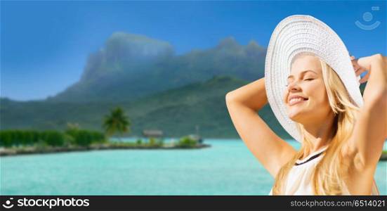 travel, tourism and summer vacation concept - beautiful woman in hat enjoying sun over exotic bora bora beach background. beautiful woman enjoying summer bora bora beach. beautiful woman enjoying summer bora bora beach