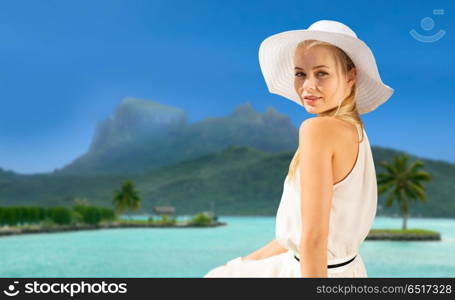 travel, tourism and summer vacation concept - beautiful woman in hat enjoying sun over exotic bora bora beach background. beautiful woman enjoying summer bora bora beach. beautiful woman enjoying summer bora bora beach