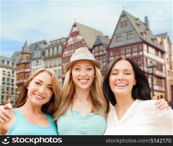travel, tourism and summer vacation concept - group of happy smiling women or friends over frankfurt am main city background. happy women over frankfurt am main background