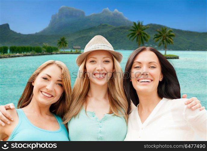 travel, tourism and summer vacation concept - group of happy smiling women or friends over bora bora background. happy women over bora bora background. happy women over bora bora background