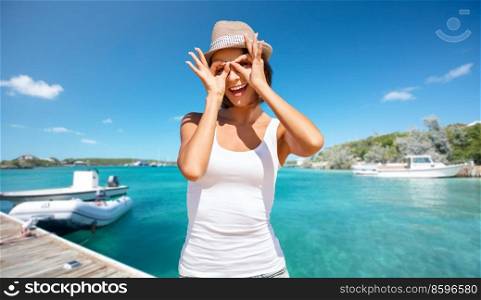 travel, tourism and summer vacation concept - happy smiling woman making funny faces over wooden pier and boat on tropical beach background in french polynesia. happy smiling woman making funny faces on beach