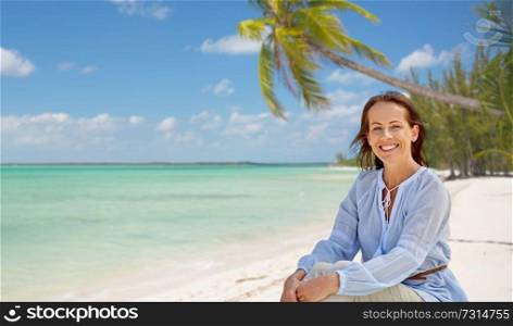 travel, tourism and summer vacation concept - happy smiling woman over tropical beach background in french polynesia. happy woman over tropical beach background