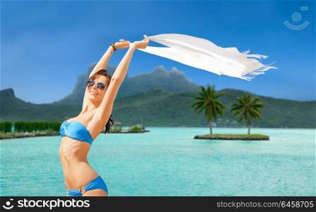 travel, tourism and summer vacation concept - woman in bikini and sunglasses at touristic resort over bora bora island beach background. woman in bikini and sunglasses on bora bora beach