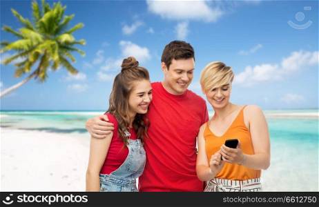 travel, tourism and technology concept - group of happy smiling friends with smartphone over exotic tropical beach background. friends with smartphone over beach background