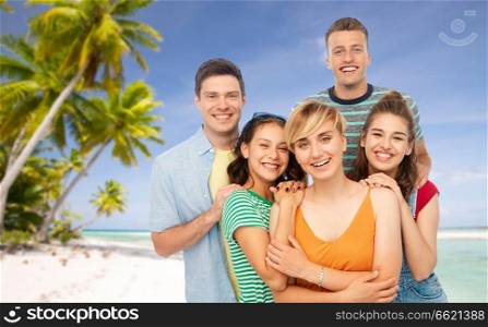 travel, tourism and vacation concept - group of happy smiling friends over tropical beach background in french polynesia. happy friends over tropical beach background