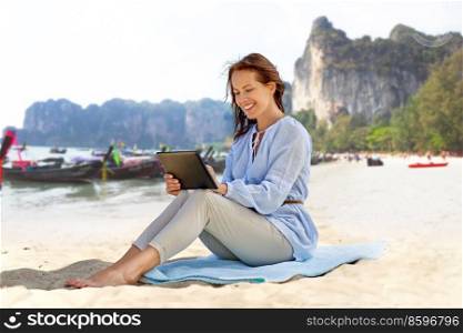 travel, tourism and vacation concept - happy smiling woman with tablet pc computer over tropical beach background in french polynesia. happy smiling woman with tablet pc on summer beach